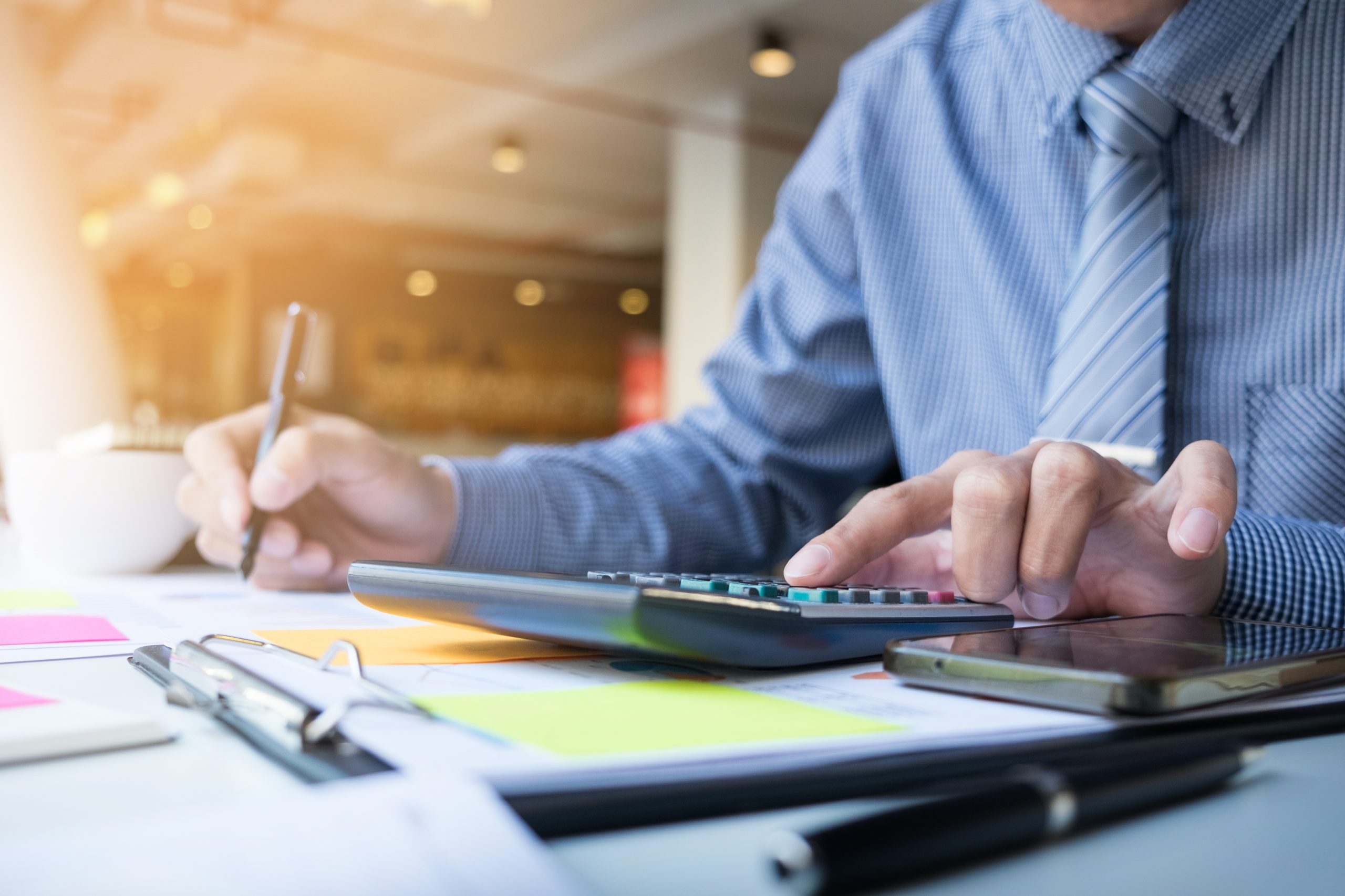 Business finance man calculating budget numbers, Invoices and fi Annuity Products
