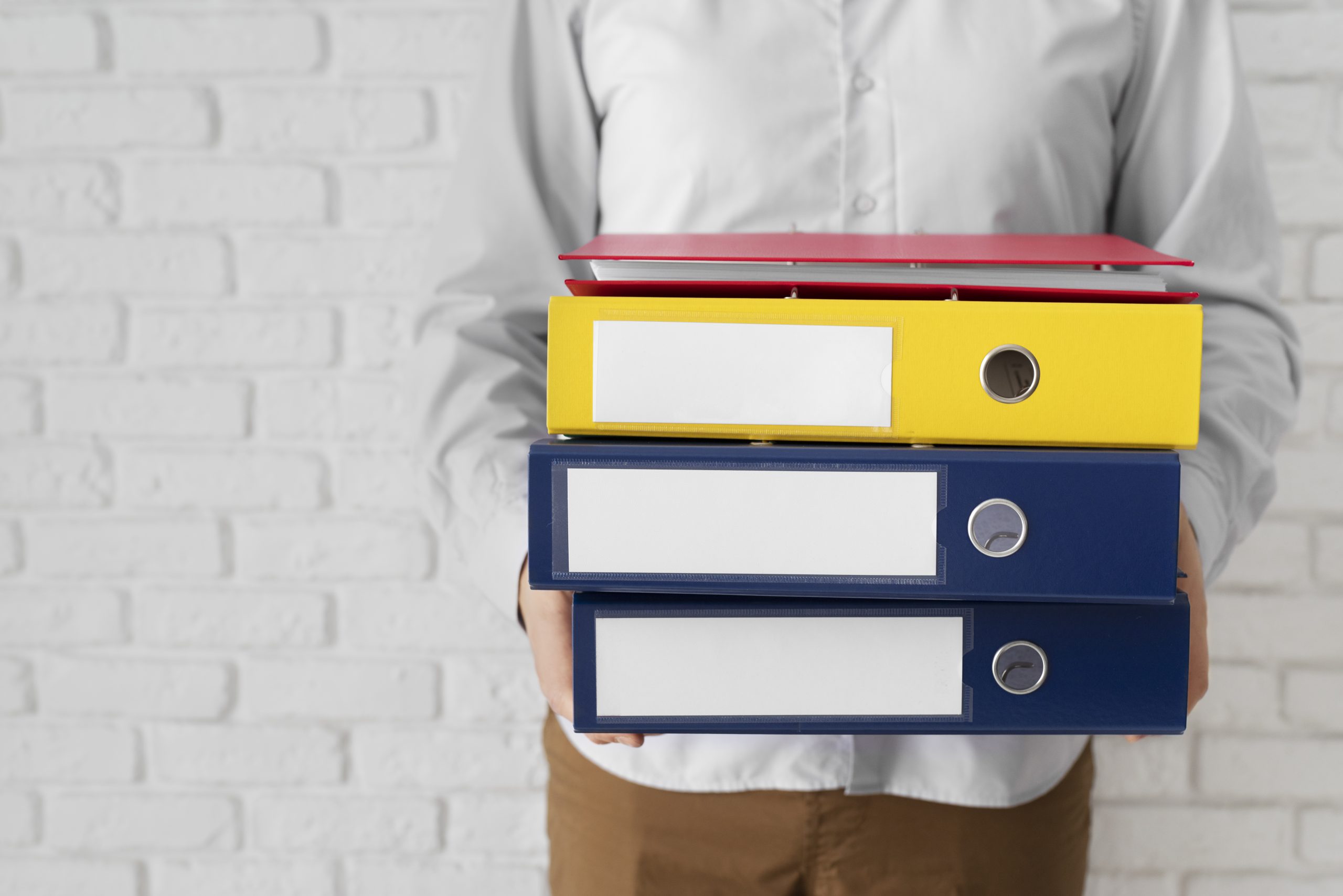 Stack of multiple policy folders symbolizing diversified private placement life insurance strategies